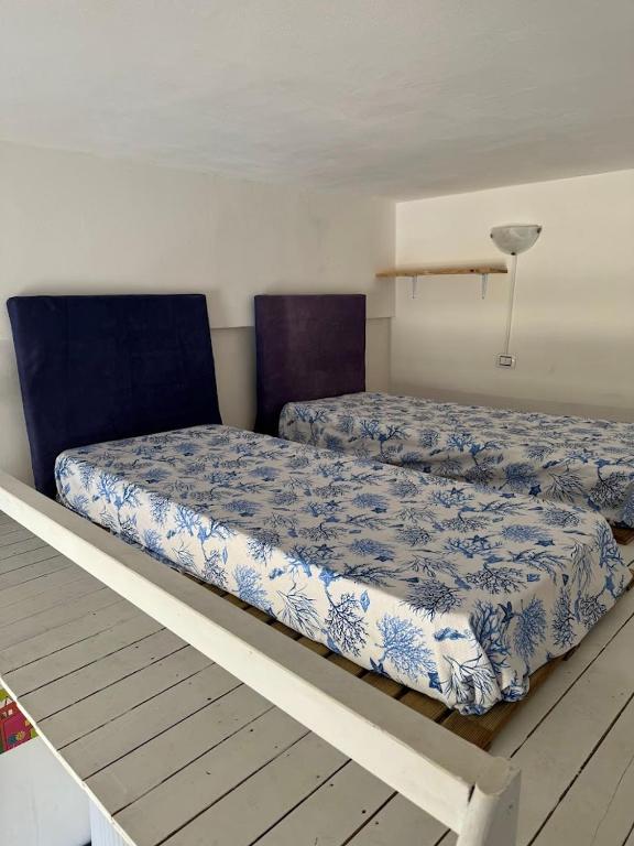 A bed or beds in a room at La Casa di Baia