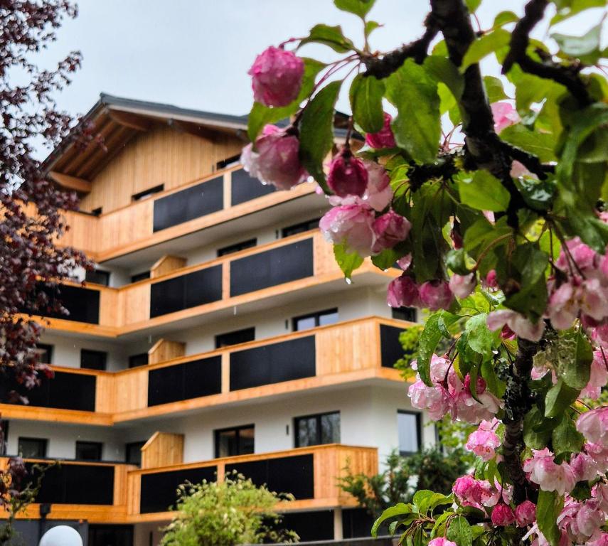 達赫施泰因山麓拉姆紹的住宿－Waldrand Apartments，前面有粉红色花的建筑