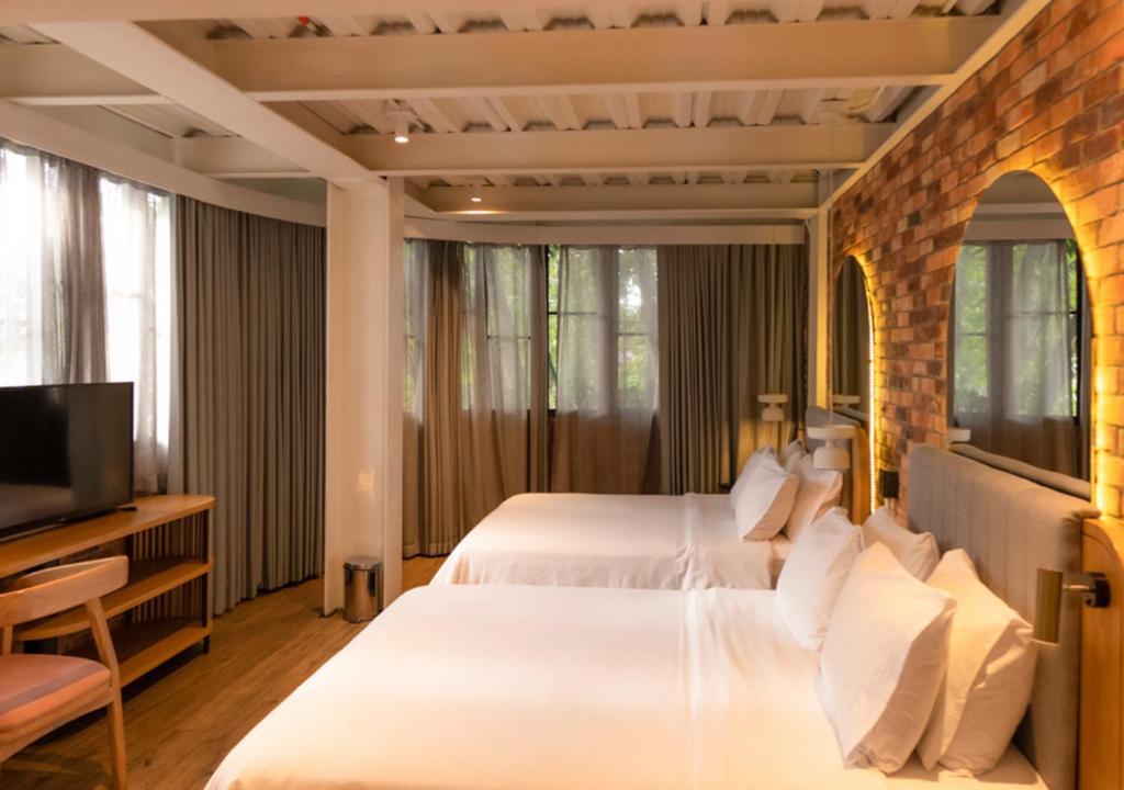 Postel nebo postele na pokoji v ubytování Nomada Hotel Origen