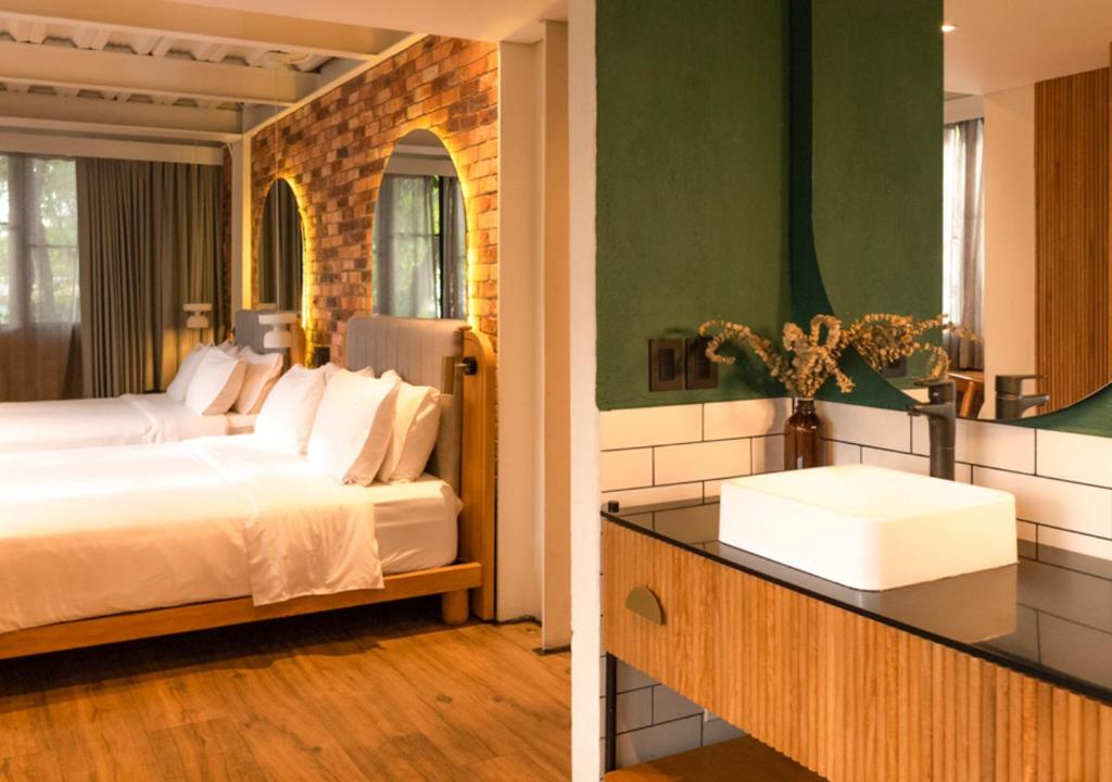 Postel nebo postele na pokoji v ubytování Nomada Hotel Origen
