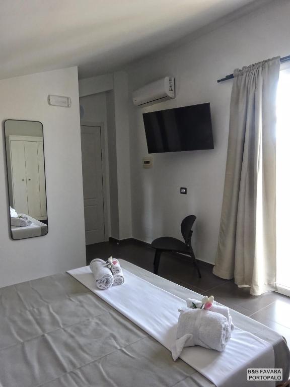 Postel nebo postele na pokoji v ubytování FAVARA Rooms