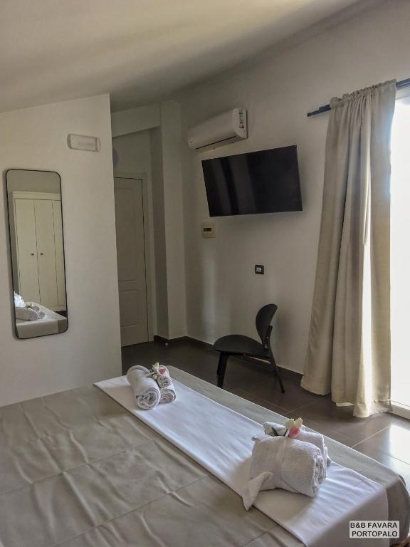 Postel nebo postele na pokoji v ubytování FAVARA Rooms