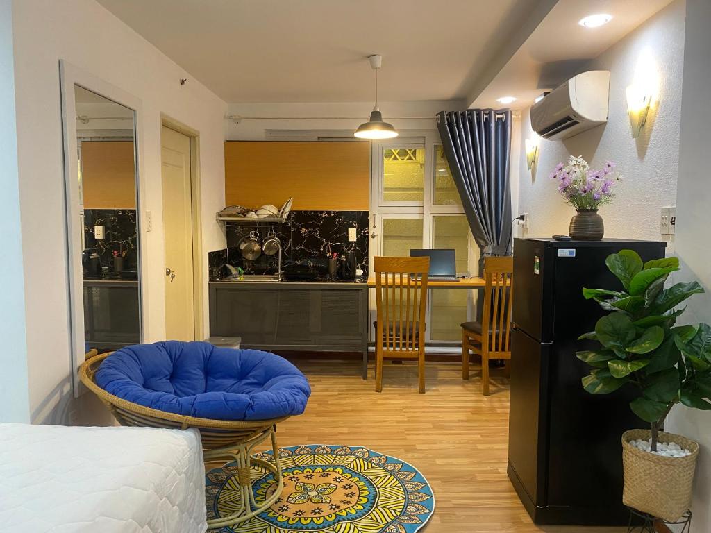 a room with a bed and a kitchen with a table at CHILL HOME 2 in Ho Chi Minh City