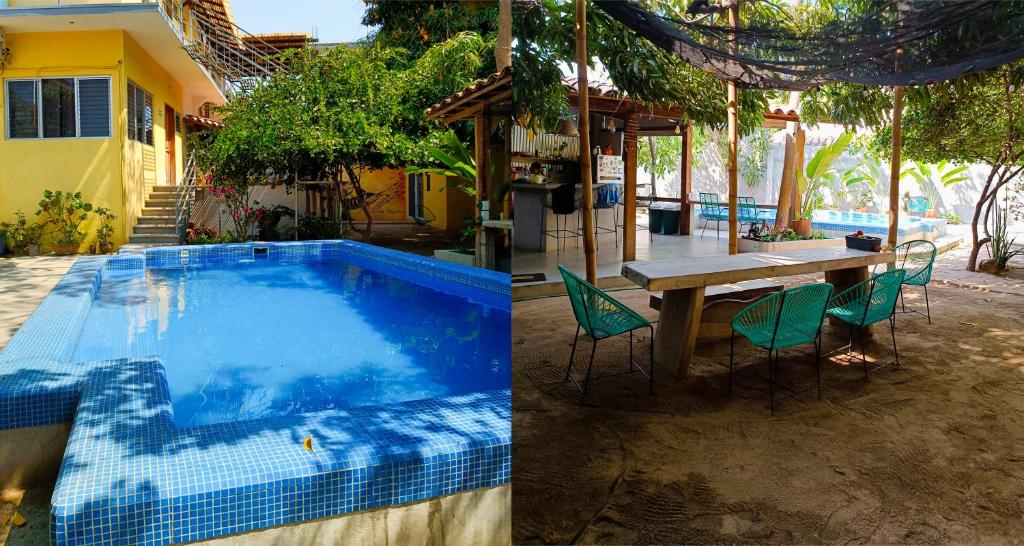 a house with a swimming pool and a table and chairs at Paziflora Hostel in Puerto Escondido