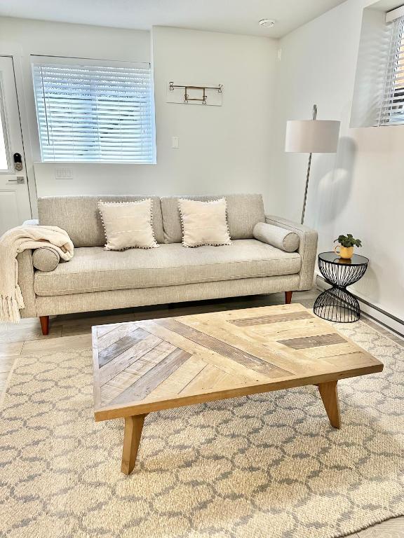 a living room with a couch and a coffee table at Homelike & cozy suite in Langley