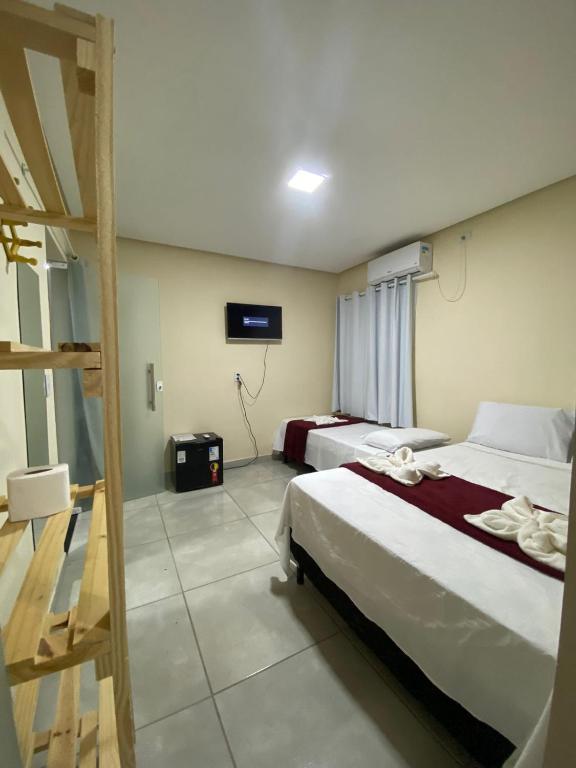 Cama ou camas em um quarto em Pousada Vista da Serra - Suzart
