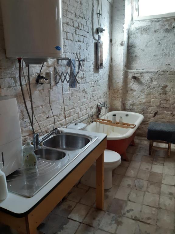 a bathroom with a sink and a toilet and a tub at Vienna Center Souterrain Atelier in Vienna