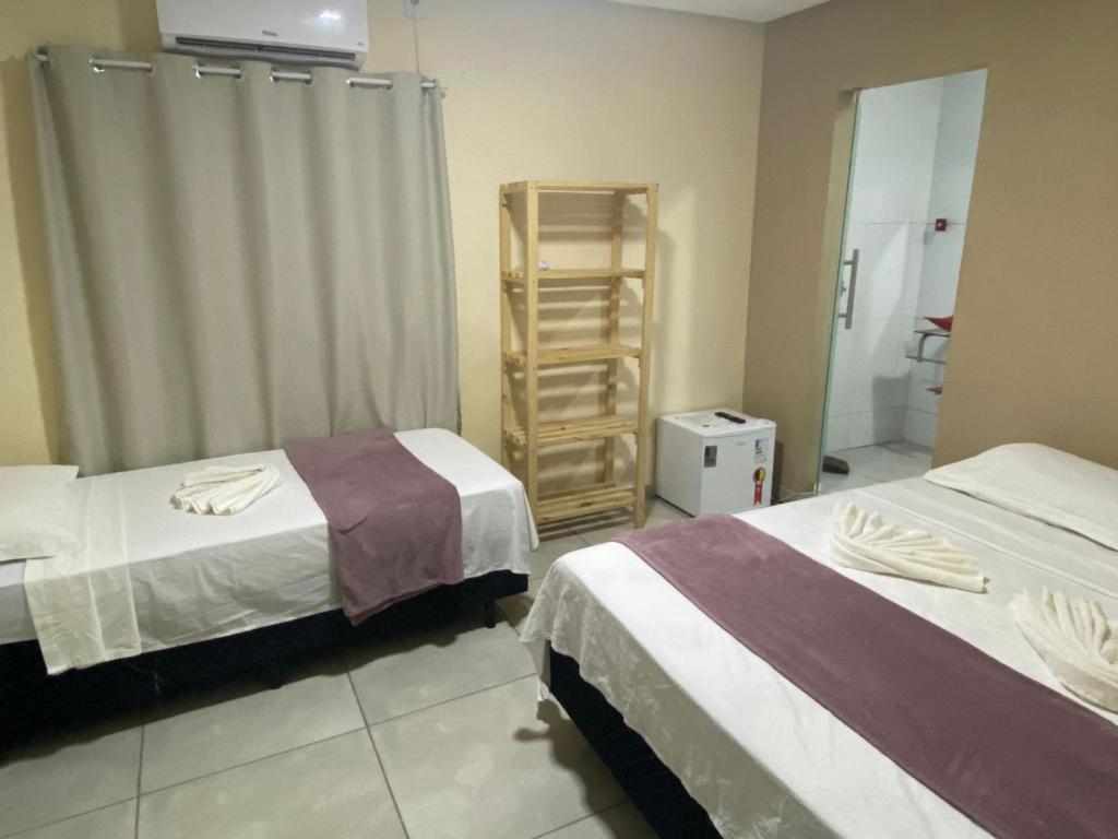 Cama ou camas em um quarto em Pousada Vista da Serra - Suzart