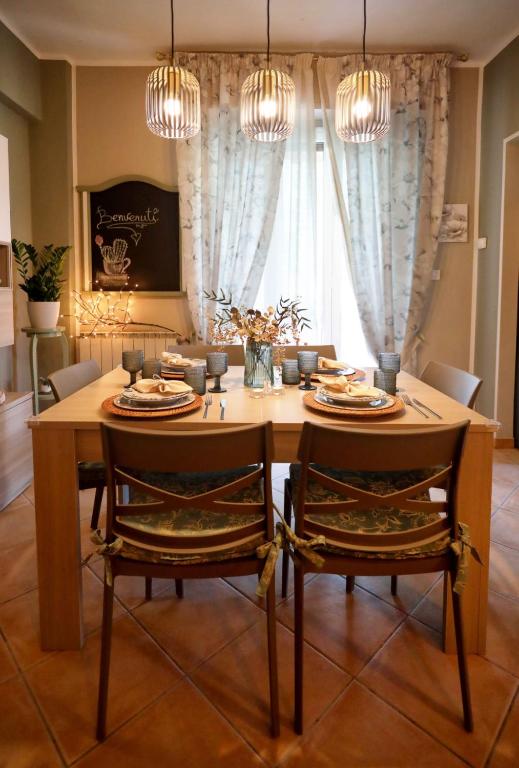 a dining room table with two chairs and chandeliers at L'Oasi tra mare e monti in Lerici