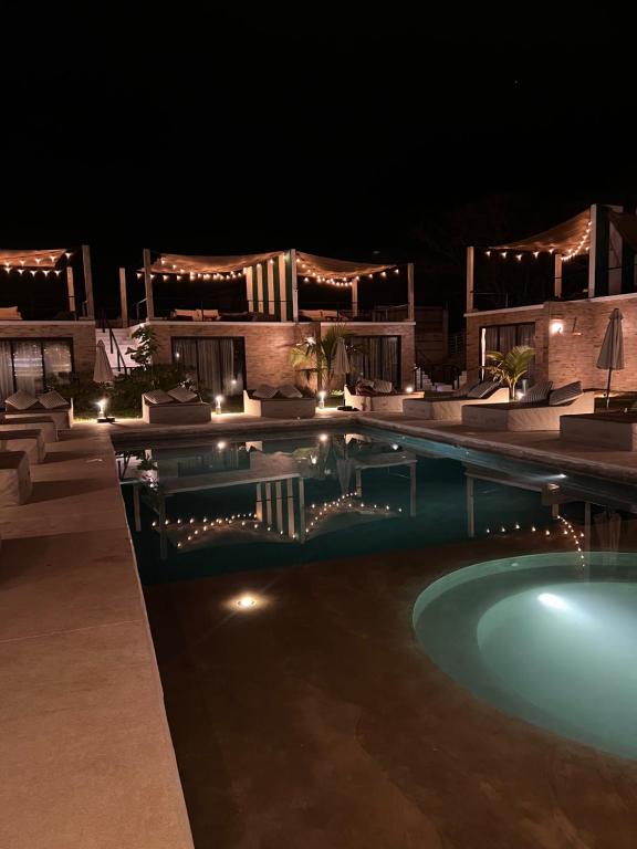 a swimming pool at night with lights at Bora Boutique - Adults Only in Puerto Escondido