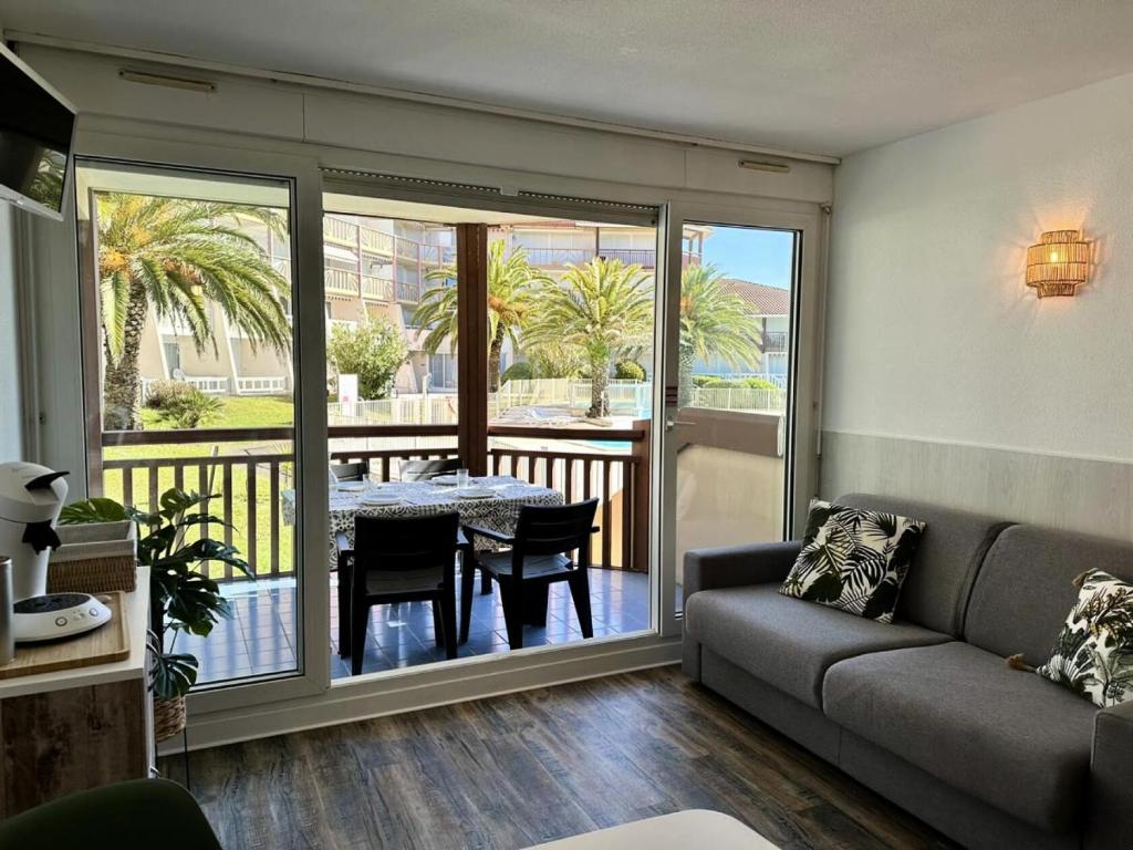 un salon avec un canapé et une table dans l'établissement Résidence Le Boucanier - Studio pour 4 Personnes 421, à Vieux-Boucau-les-Bains