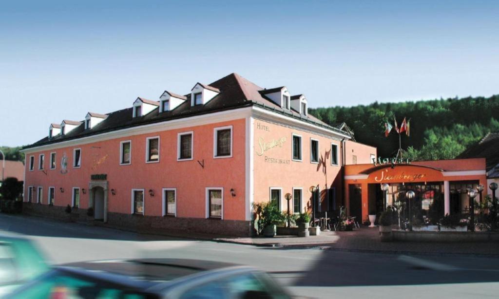 a large red building on the side of a street at Das Steinberger in Altlengbach