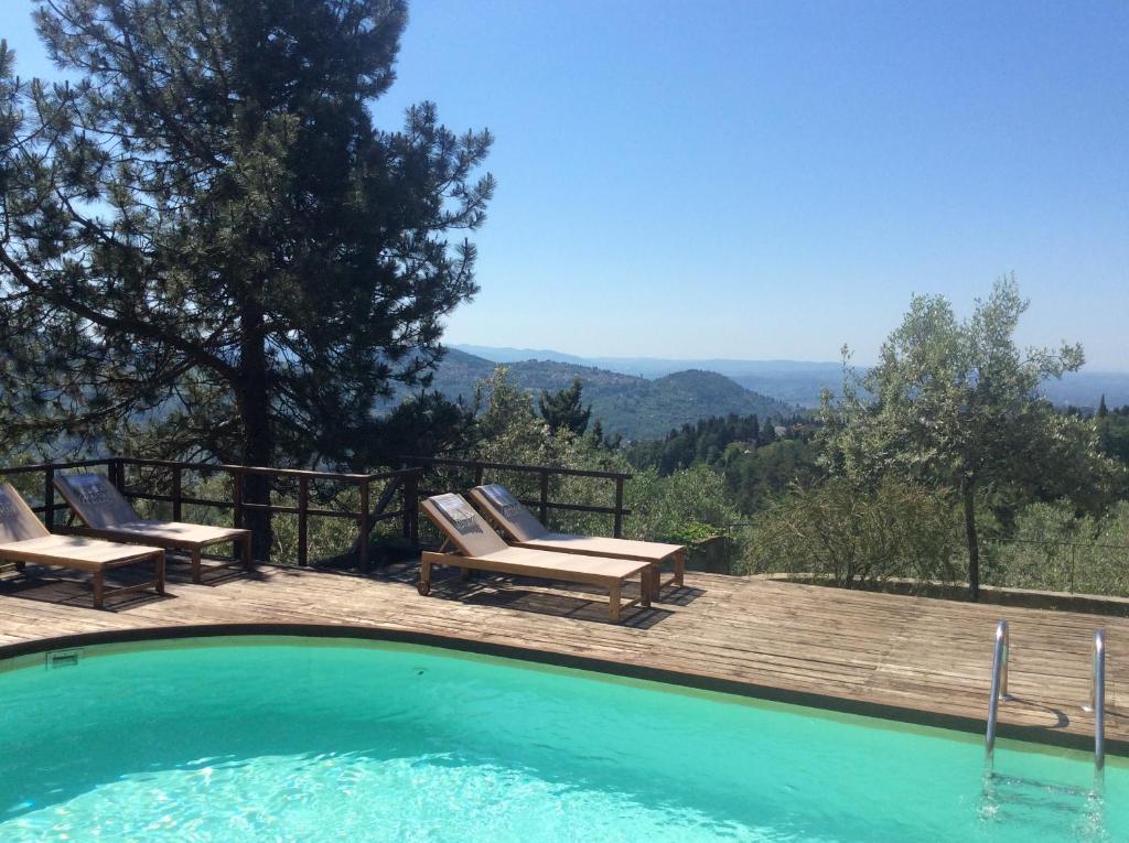 una piscina con sillas y vistas a las montañas en Bed Breakfast La Paggeria, en Trespiano