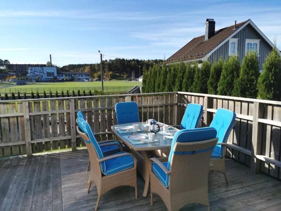 a patio with a table and chairs on a deck at Holiday Appartement in Brevik in Porsgrunn