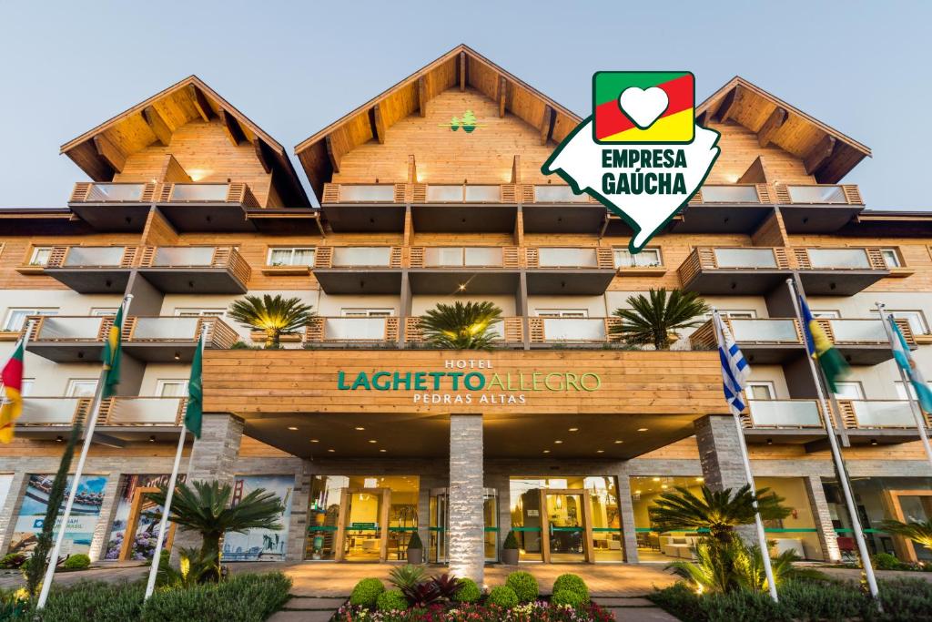 un hotel con un cartel en la parte delantera en Hotel Laghetto Pedras Altas, en Gramado