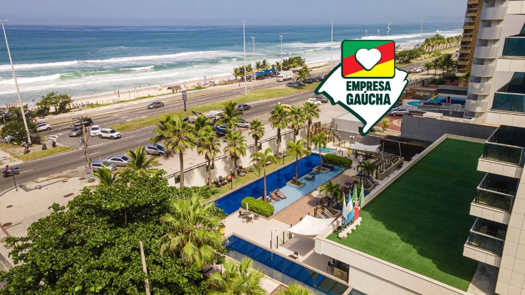 an aerial view of a hotel and the beach at Laghetto Stilo Barra in Rio de Janeiro