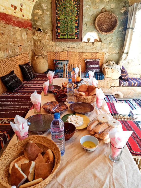 a table with bread and other food on it at Gite Douiret in Ad Duwayrāt