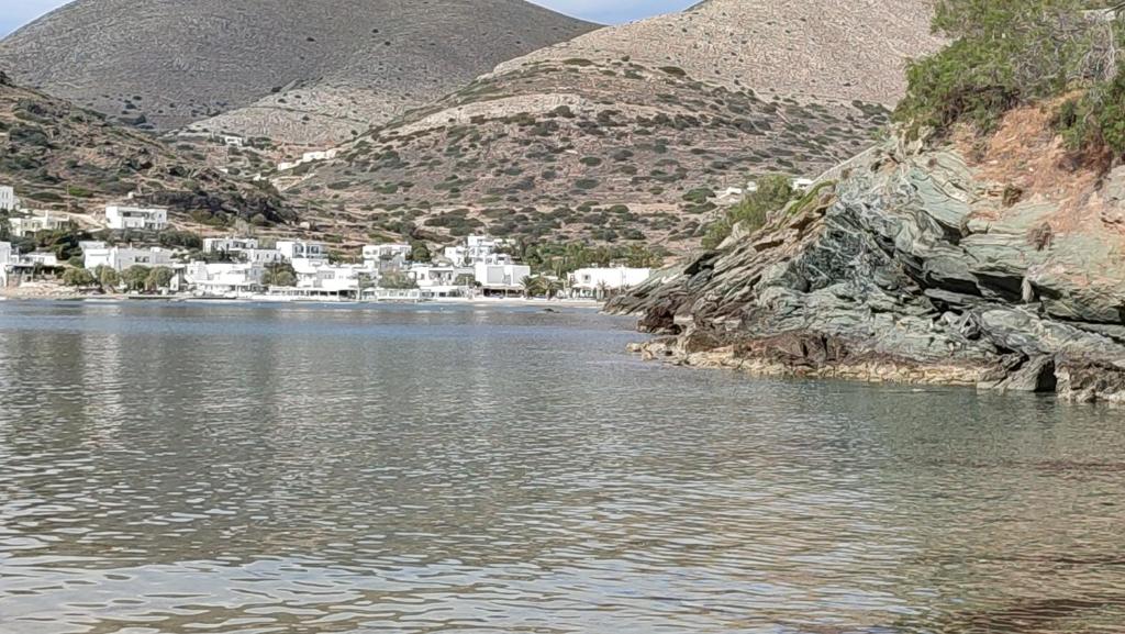 a body of water with houses on the side of a mountain at White Lotus seaside apartment in Kinion