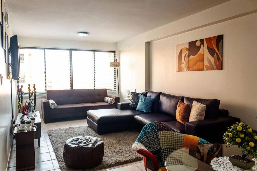 a living room with a couch and a table at Cozy Apartment in Maracaibo in Maracaibo