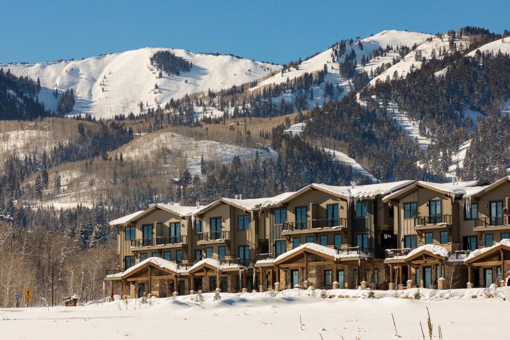 a resort in the snow with mountains in the background at Park City Family Retreats at The Canyons in Park City