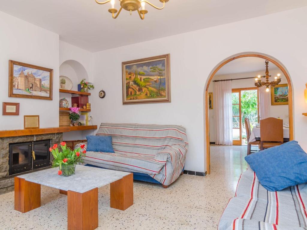 a living room with a couch and a table at Can Nicolau - Villa With Private Pool In Colònia De Sant Pere Free Wifi in Colonia de Sant Pere