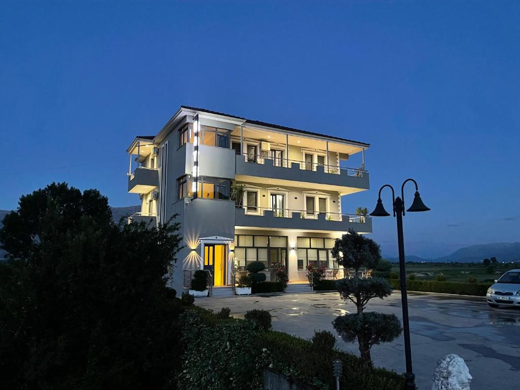 a large white building with its lights on at Hotel Selfo in Gjirokastër