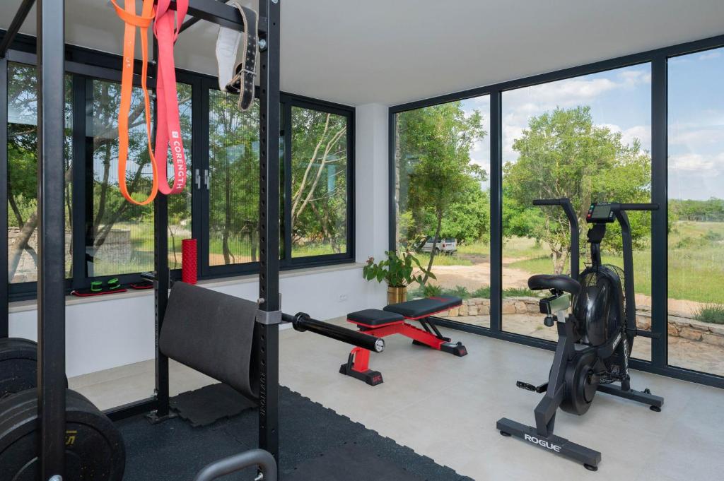 a gym with two treadmills and two exercise bikes at Nono Ban Hotel & Villa in Gornji Humac