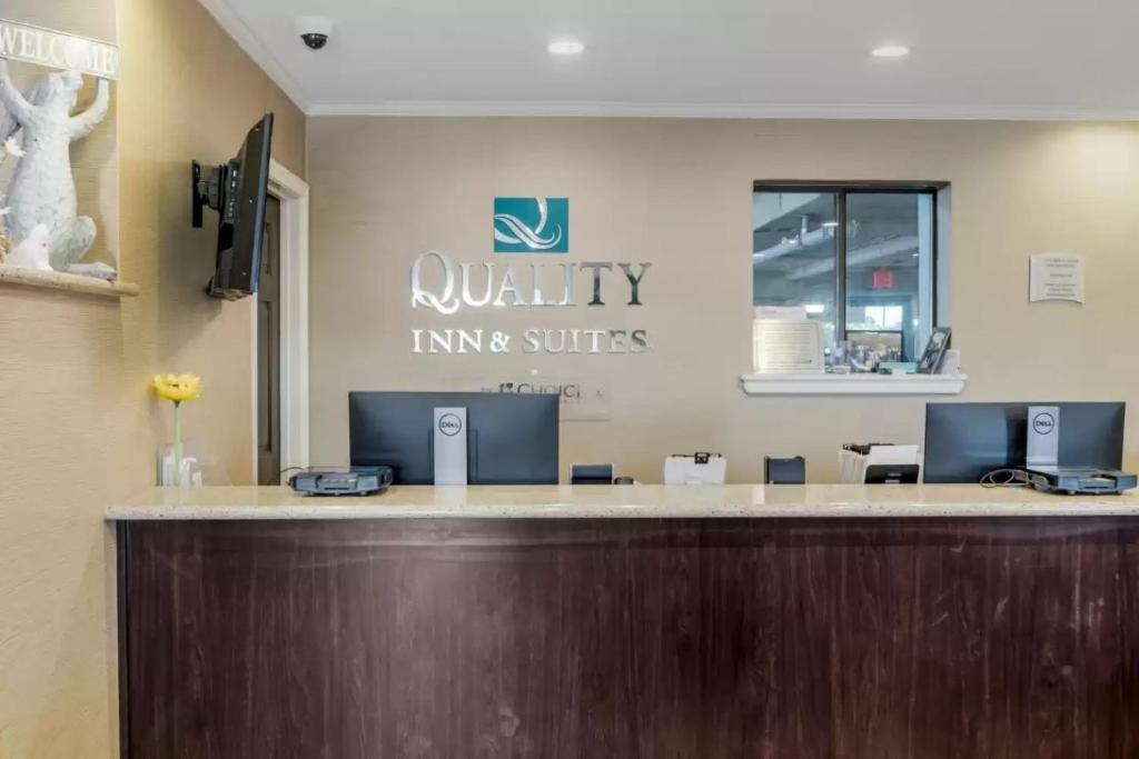 a reception desk in a waiting room with a sign at Quality Inn & Suites Oceanblock in Ocean City