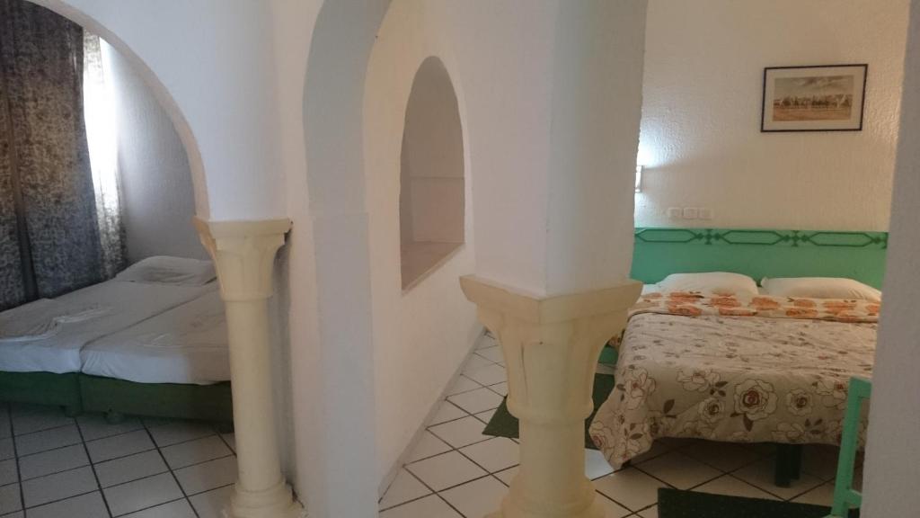 Postel nebo postele na pokoji v ubytování Hotel Le Khalife