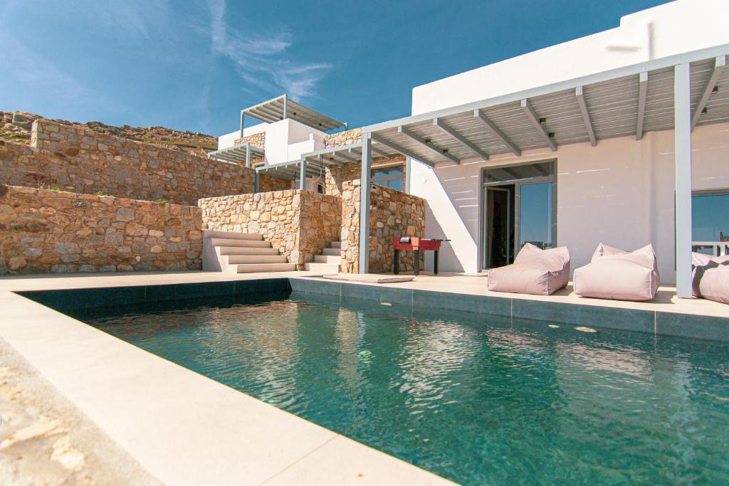a swimming pool in front of a house at Summer Villa Barbara ,private pool in Mikonos