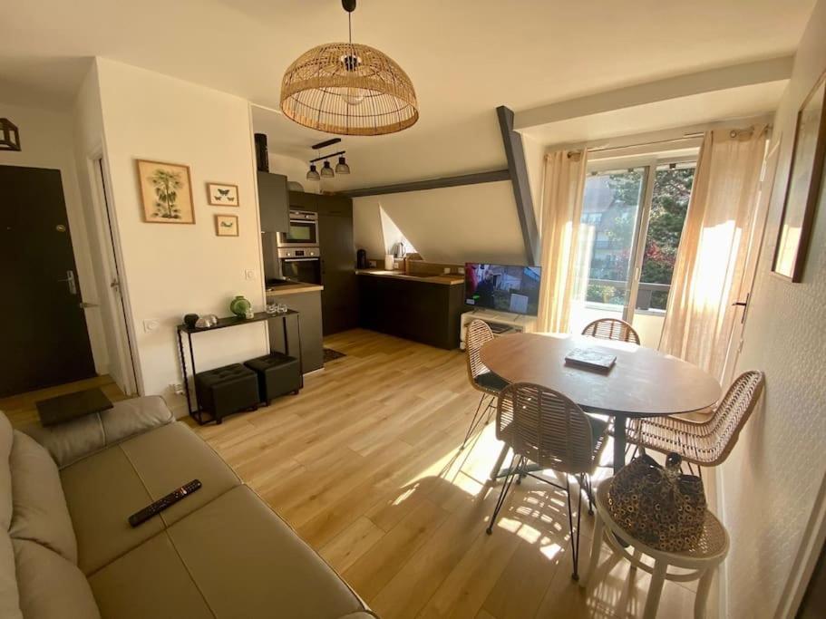 a living room with a couch and a table and chairs at La douce escapade, Superbe T2, 4 pers - parking, balcon in Villers-sur-Mer