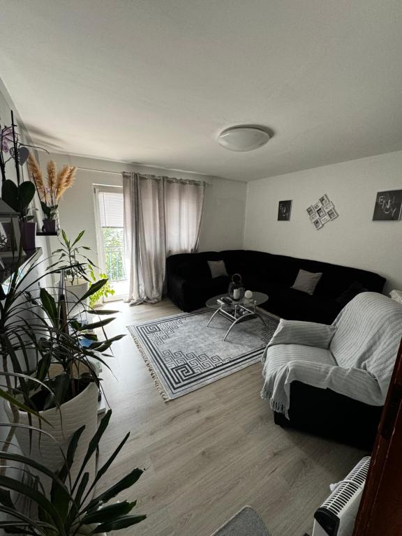 a living room with a black couch and a table at Apartment Danijela in Senj