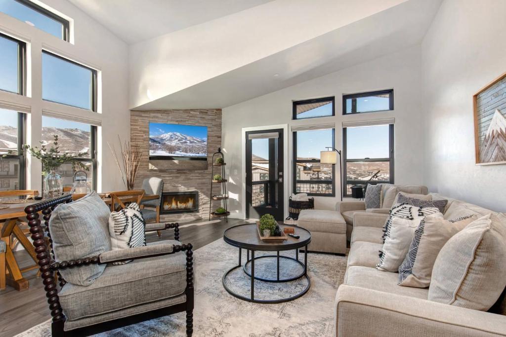 a living room with a couch and chairs and a fireplace at Mayflower Lakeside 301-21 by Moose Management in Heber City