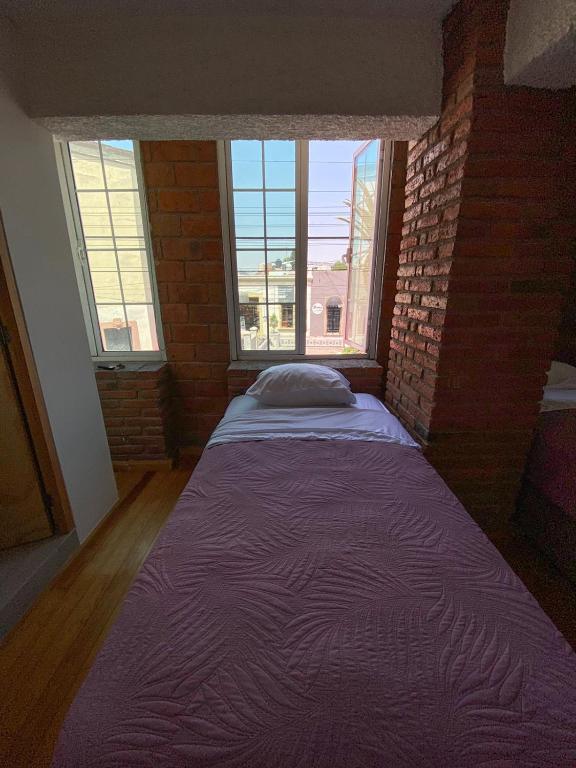 Postel nebo postele na pokoji v ubytování Hotel RJ Querétaro