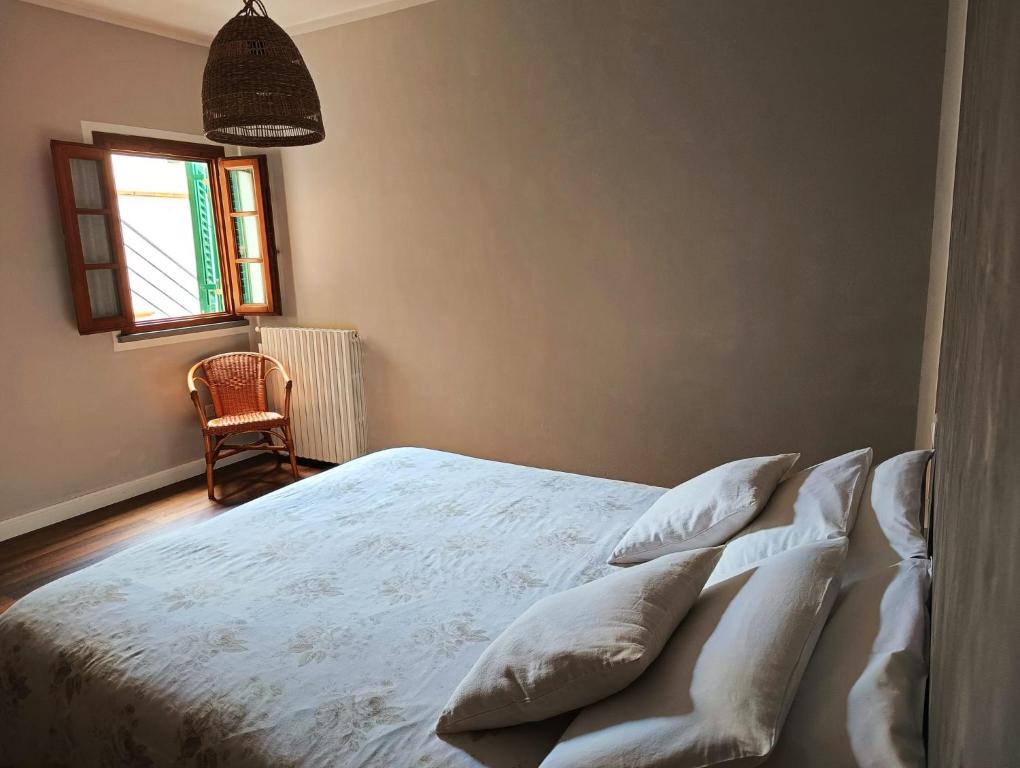 a bedroom with a bed with white sheets and pillows at Loft 21 in Empoli