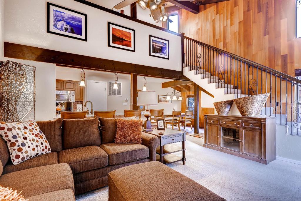 a living room with a couch and a fireplace at Lakeland Village 480 - Remodeled Close to Skiing 2BRLoft in South Lake Tahoe