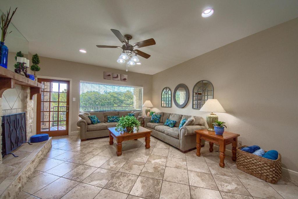 a living room with two couches and a fireplace at River Zen CW C207 in New Braunfels