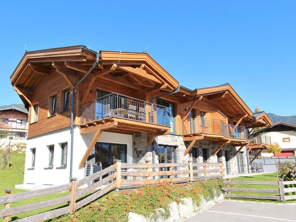 a large wooden house with balconies on it at Luxury Tauern Suite Walchen-Kaprun 3 in Piesendorf
