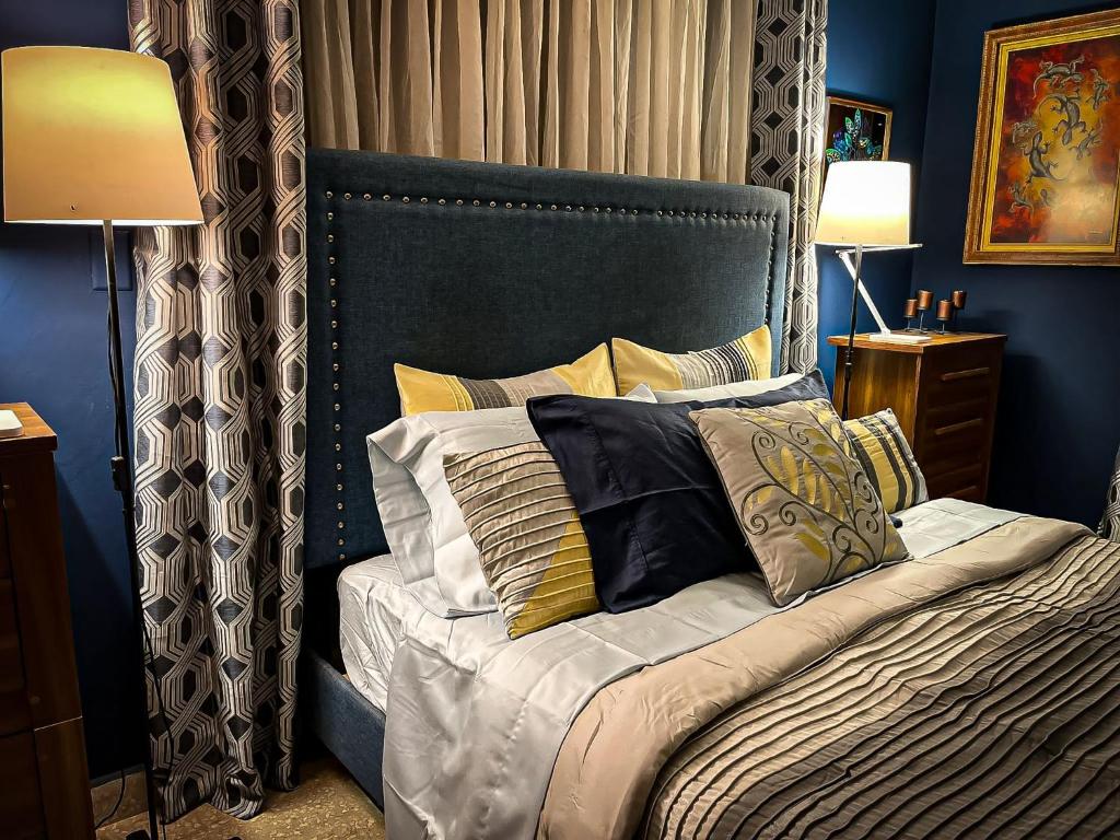 a blue bedroom with a bed with pillows at ORHO HOTEL BOUTIQUE PANAMA Tocumen Airport free shuttle highway round trip 15 minuts in Tocumen
