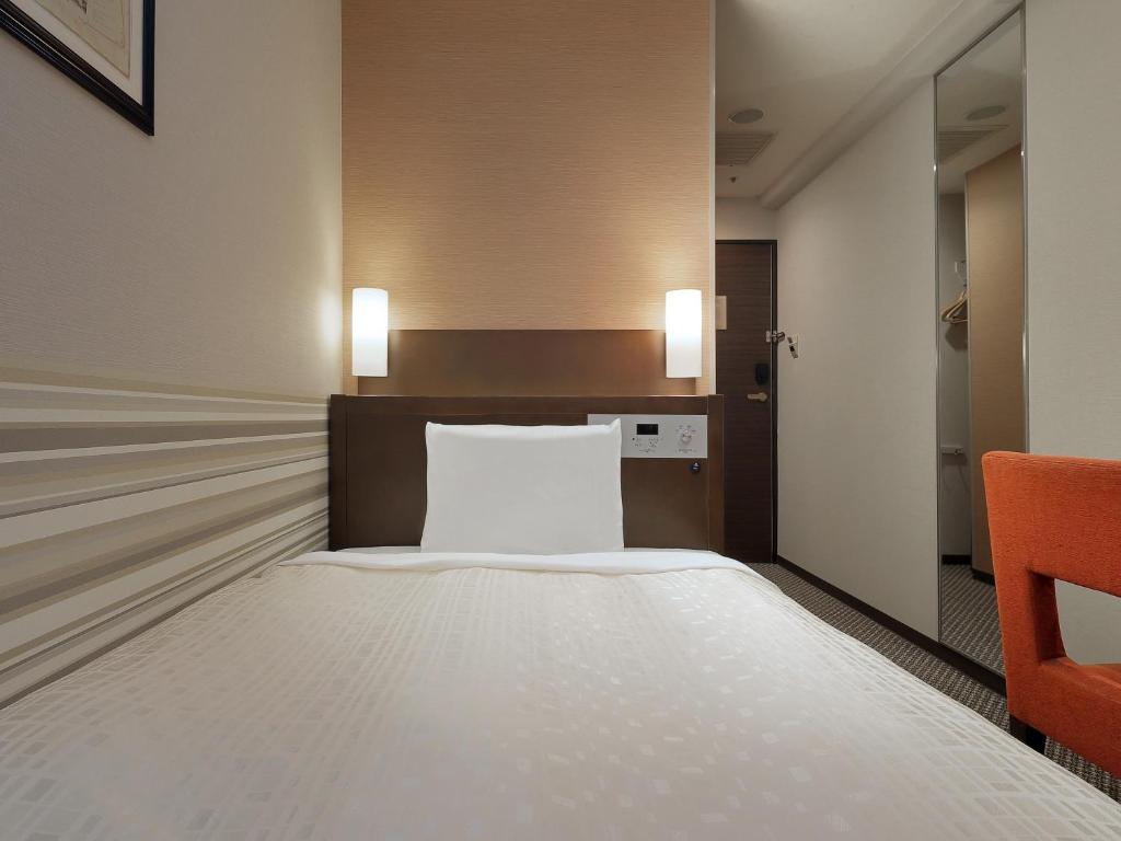 Postel nebo postele na pokoji v ubytování Keio Presso Inn Kanda