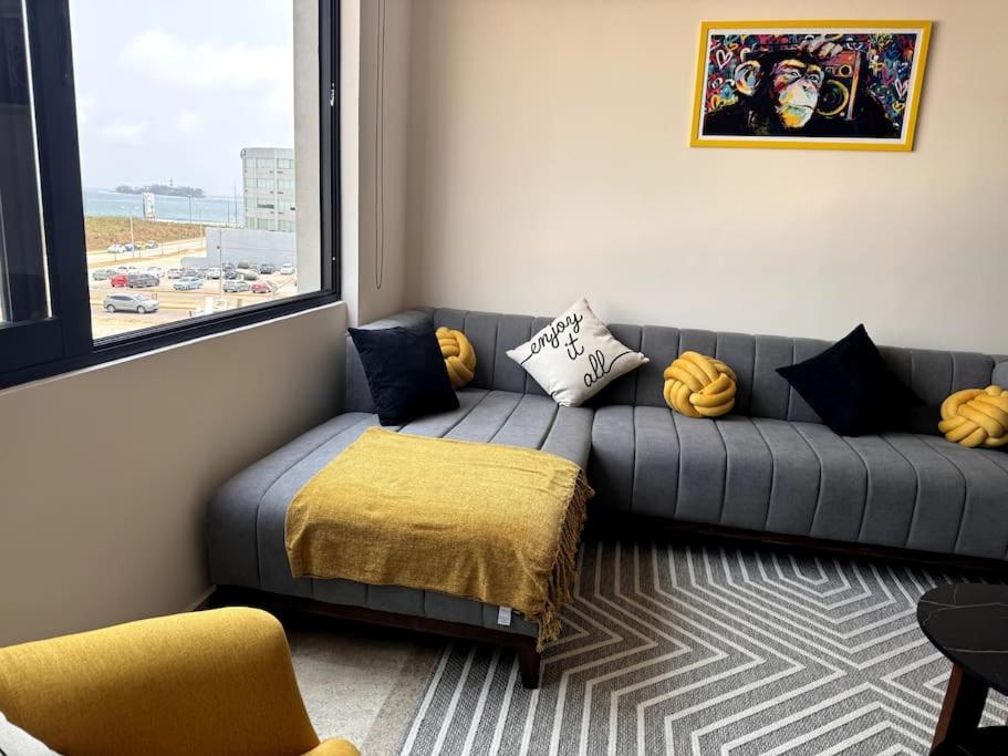 a living room with a couch and a window at Depa Luxe 2HAB con Alberca y Playa Caminando in Boca del Río
