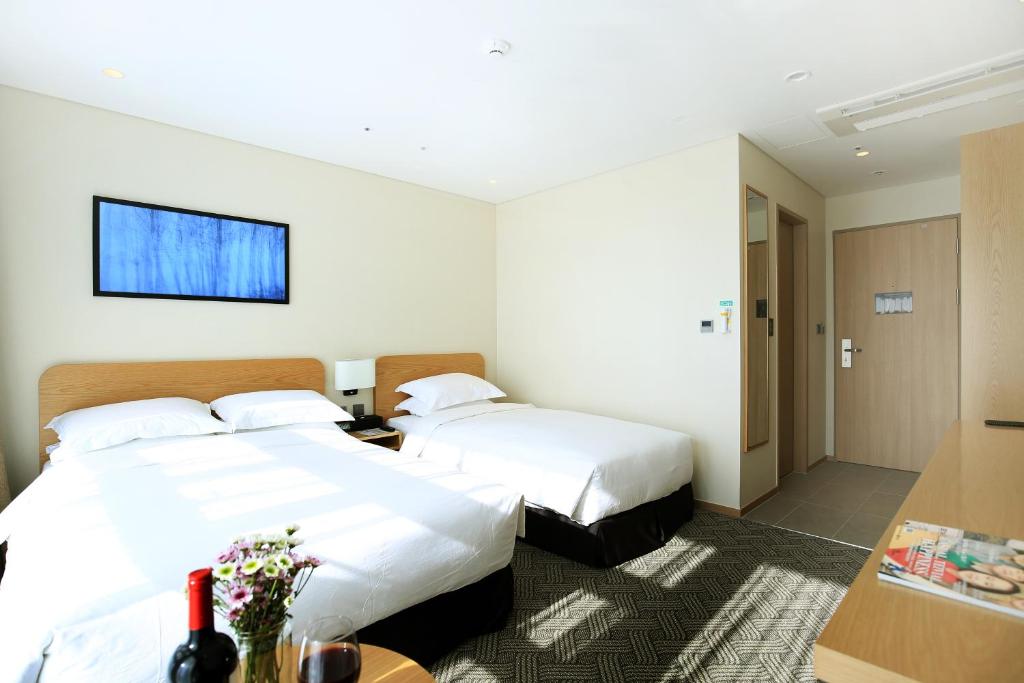 Postel nebo postele na pokoji v ubytování Best Western Haeundae Hotel