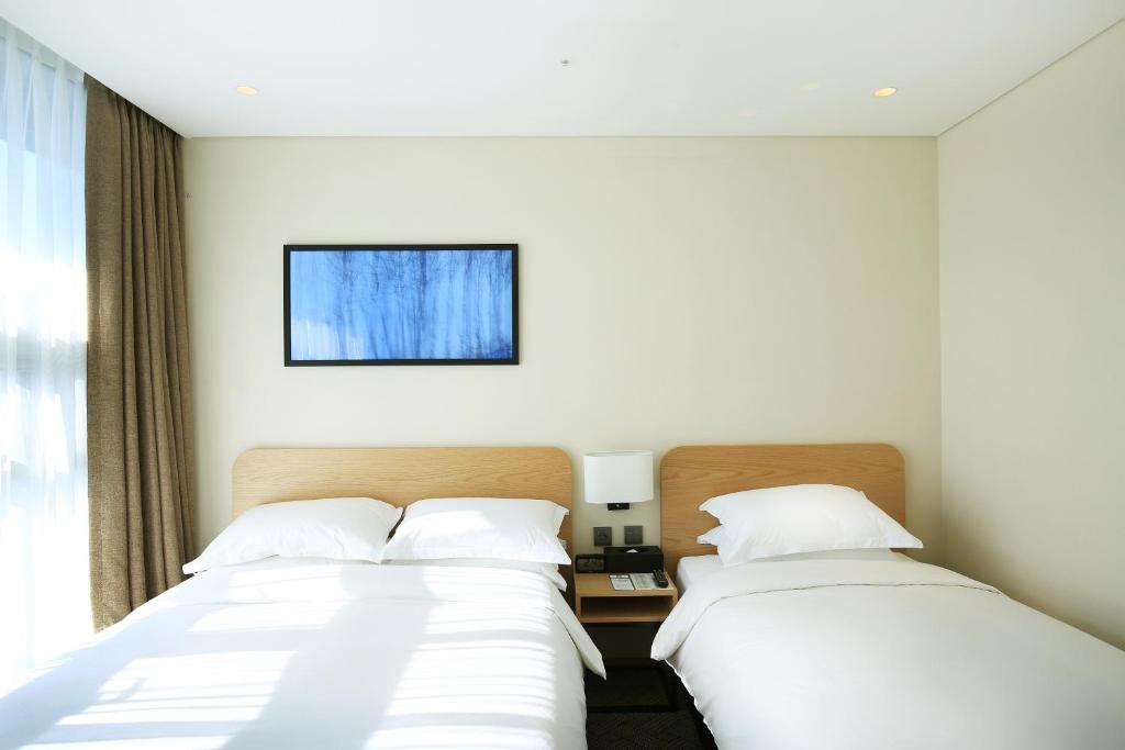 Postel nebo postele na pokoji v ubytování Best Western Haeundae Hotel