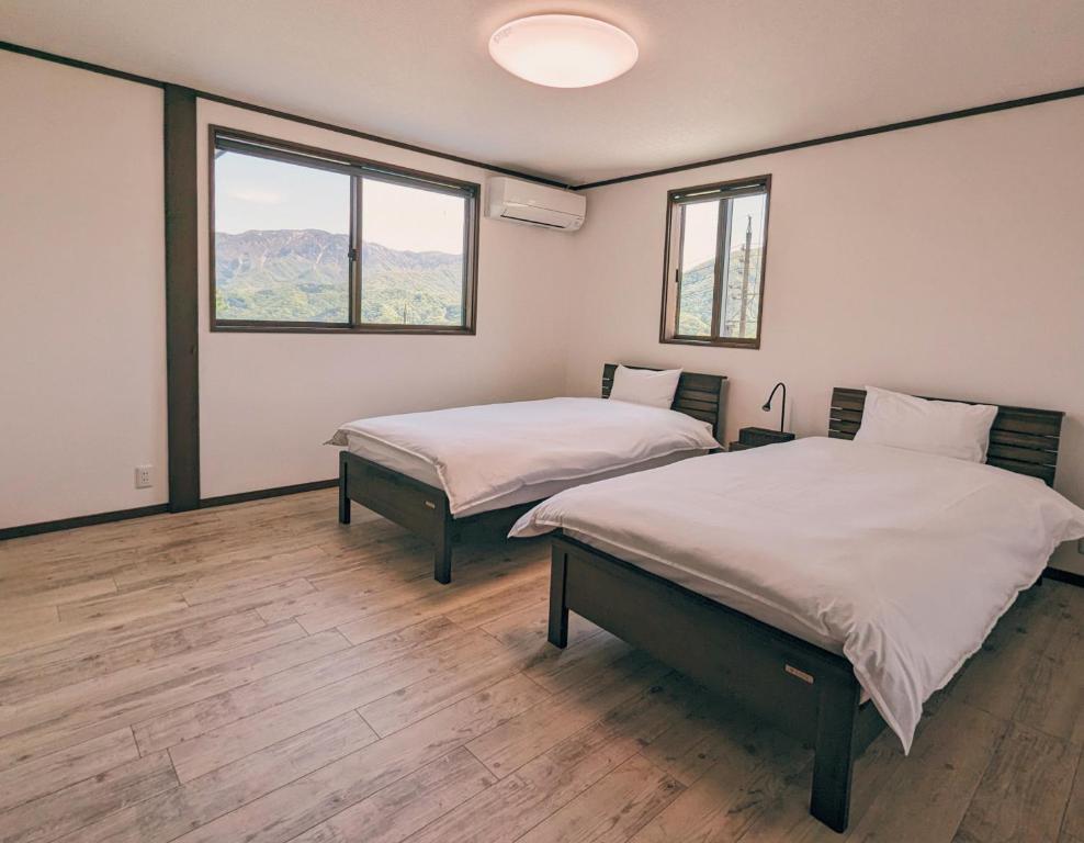 Postel nebo postele na pokoji v ubytování Crows Nest Norikura