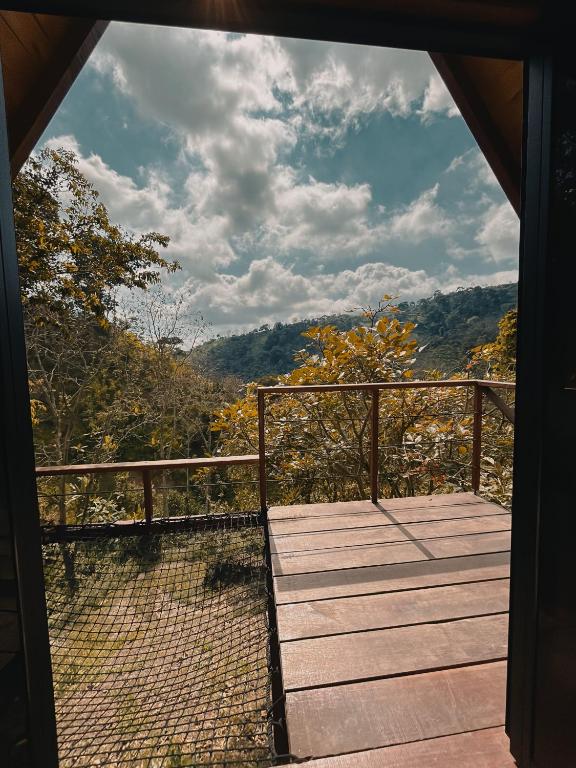 a view from the porch of a house with a wooden deck at Glampling Dos Quebradas in Floridablanca