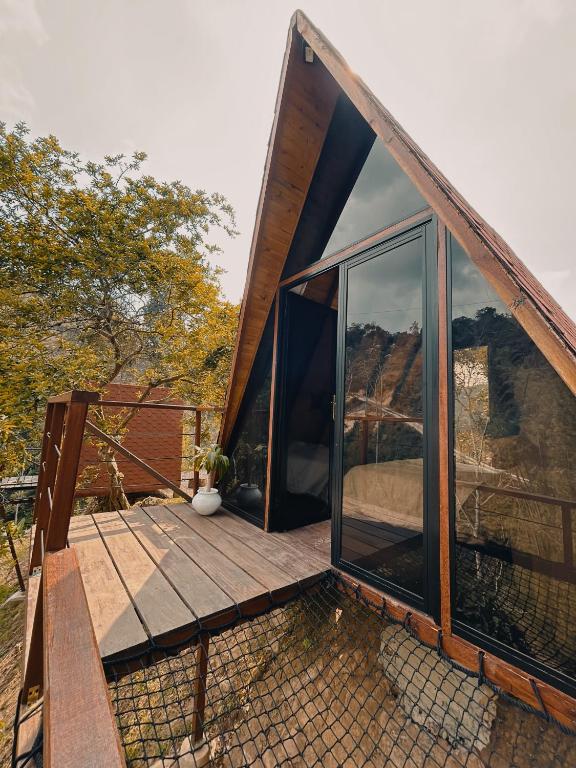a house with a deck with sliding glass doors at Glampling Dos Quebradas in Floridablanca