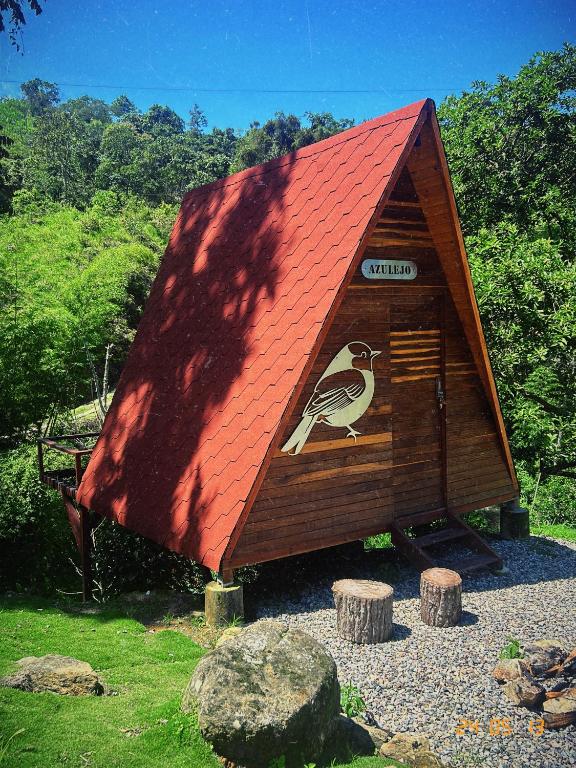 a small house with a bird painted on the side of it at Glampling Dos Quebradas in Floridablanca