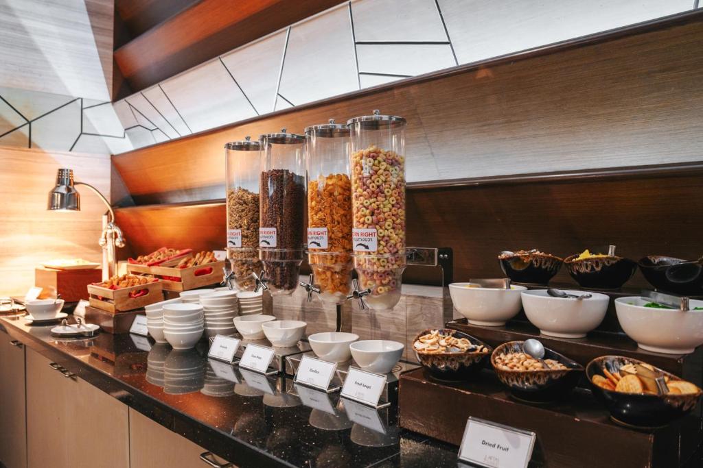 A cereal and bakery section of a self-service breakfast buffet.