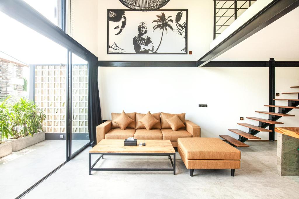 a living room with a couch and a coffee table at Spacious Loft 200m From Canggu Beach in Canggu