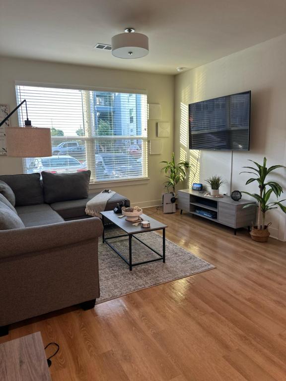 a living room with a couch and a table at Devine living in the med center in Houston